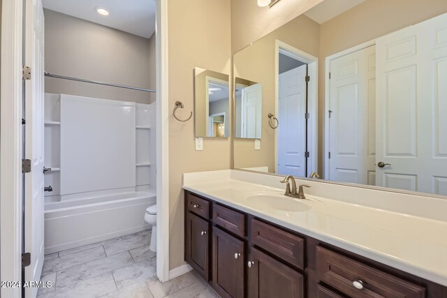 full bathroom with shower / tub combination, vanity, and toilet