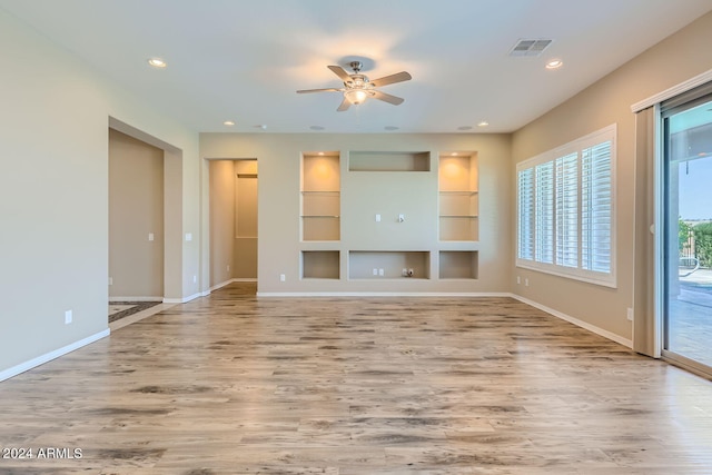 unfurnished living room with ceiling fan and hardwood / wood-style floors