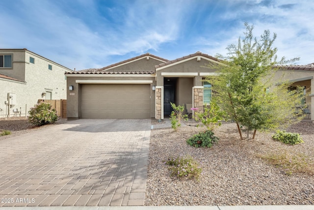 3699 E Sweetclover Ln, San Tan Valley, AZ 85140 - view of front of house with stone siding, decorative driveway, an attached garage, a tile roof, and stucco siding