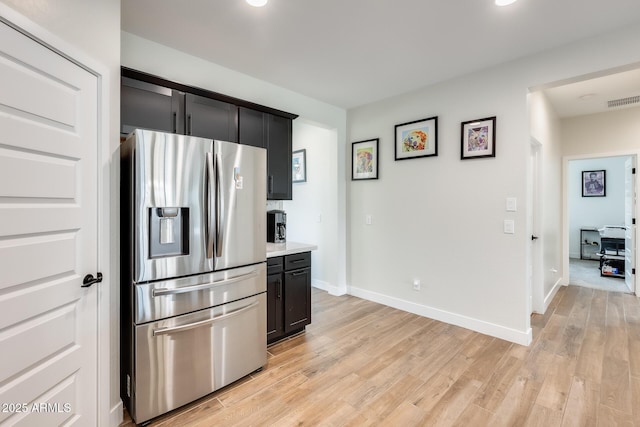 3699 E Sweetclover Ln, San Tan Valley, AZ 85140 - kitchen featuring light countertops, stainless steel refrigerator with ice dispenser, baseboards, light wood finished floors, and visible vents