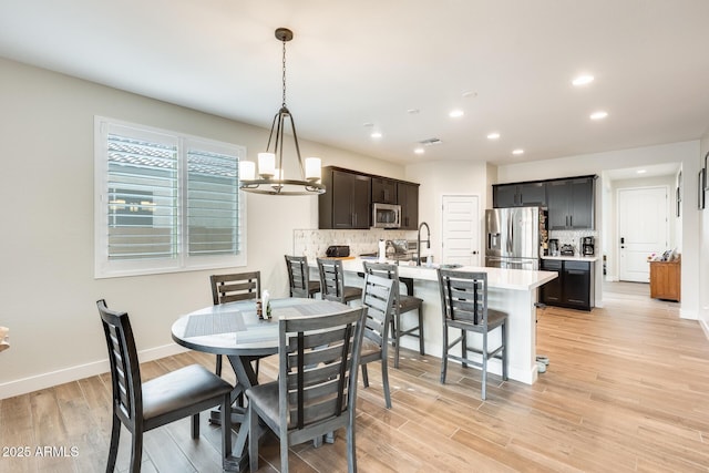 3699 E Sweetclover Ln, San Tan Valley, AZ 85140 - dining space with baseboards, light wood-style flooring, a chandelier, and recessed lighting