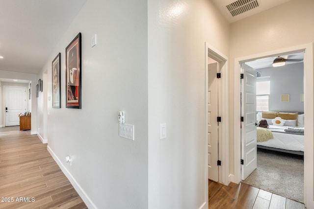 3699 E Sweetclover Ln, San Tan Valley, AZ 85140 - corridor with light wood-type flooring, baseboards, and visible vents
