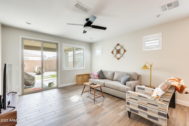 3699 E Sweetclover Ln, San Tan Valley, AZ 85140 - living room with ceiling fan, baseboards, light wood finished floors, and visible vents