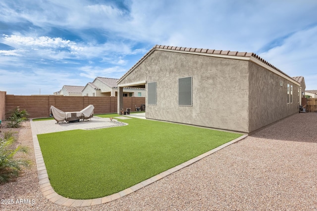 3699 E Sweetclover Ln, San Tan Valley, AZ 85140 - rear view of property featuring a fenced backyard, a lawn, stucco siding, and a patio