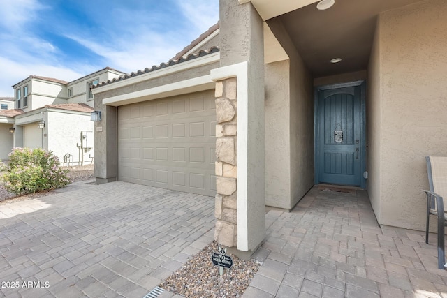 3699 E Sweetclover Ln, San Tan Valley, AZ 85140 - doorway to property featuring a tiled roof, driveway, stucco siding, and an attached garage