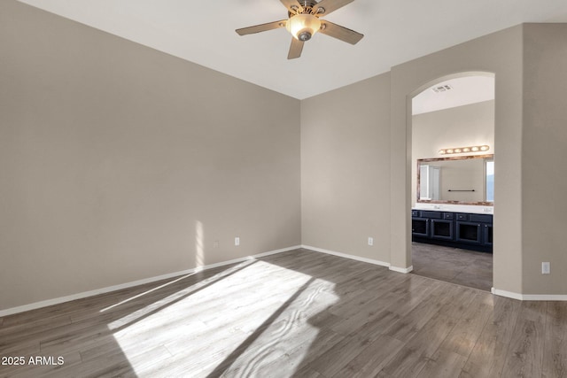 empty room featuring dark wood-type flooring and ceiling fan