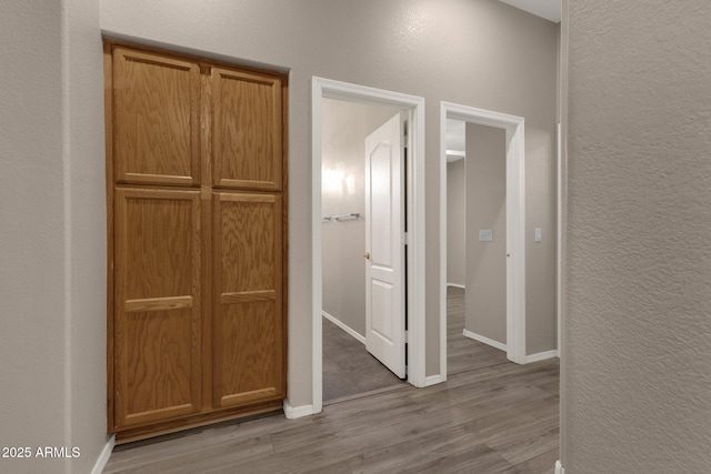 hall with light hardwood / wood-style flooring