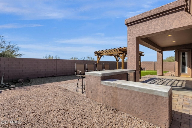 view of yard featuring a patio, a pergola, and an outdoor bar