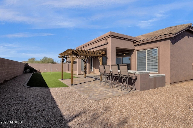 view of patio with a bar and a pergola