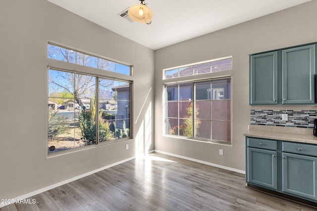 unfurnished dining area with a healthy amount of sunlight and light wood-type flooring