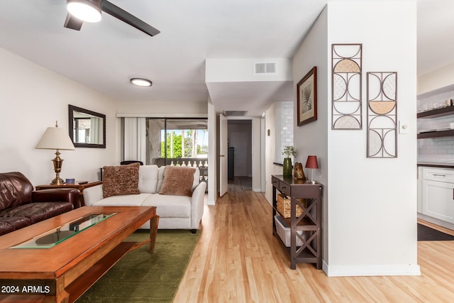 living room featuring ceiling fan and light hardwood / wood-style floors