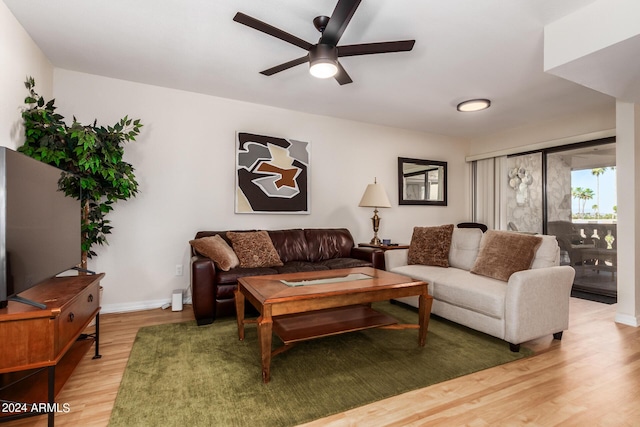 living room with hardwood / wood-style flooring and ceiling fan