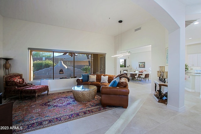 32472 N 68th Pl, Scottsdale, AZ 85266 - living room with light tile patterned flooring, arched walkways, recessed lighting, a towering ceiling, and visible vents