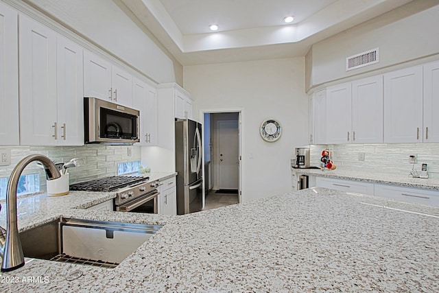 32472 N 68th Pl, Scottsdale, AZ 85266 - kitchen featuring a sink, appliances with stainless steel finishes, light stone counters, and visible vents