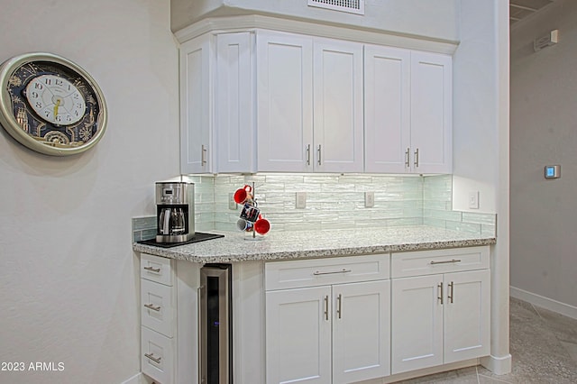 32472 N 68th Pl, Scottsdale, AZ 85266 - kitchen featuring baseboards, light stone counters, beverage cooler, and white cabinetry