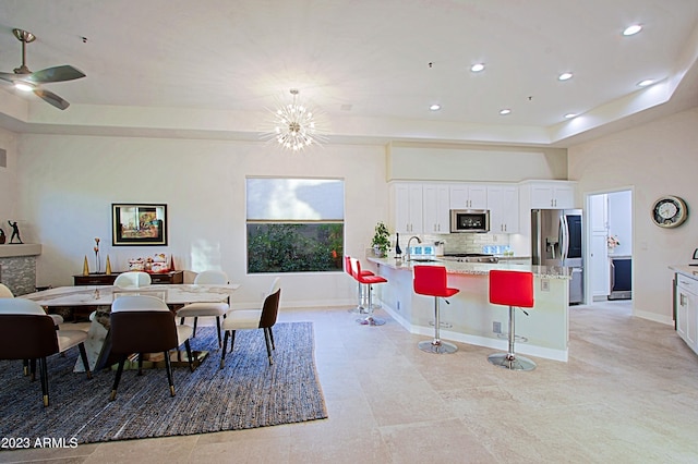32472 N 68th Pl, Scottsdale, AZ 85266 - dining room featuring recessed lighting, a raised ceiling, and ceiling fan with notable chandelier