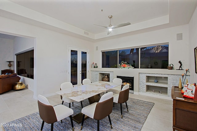 32472 N 68th Pl, Scottsdale, AZ 85266 - dining area with a ceiling fan, visible vents, light tile patterned floors, a glass covered fireplace, and a tray ceiling