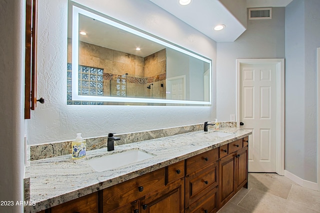 32472 N 68th Pl, Scottsdale, AZ 85266 - full bath featuring visible vents, double vanity, baseboards, a walk in shower, and a sink