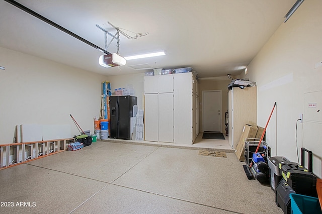 32472 N 68th Pl, Scottsdale, AZ 85266 - garage featuring black fridge and a garage door opener