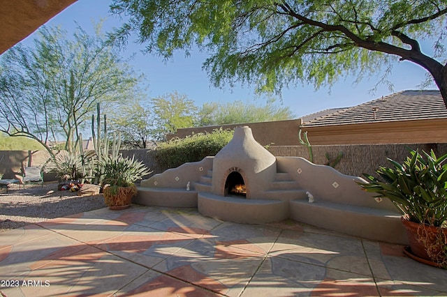 32472 N 68th Pl, Scottsdale, AZ 85266 - view of patio featuring a fenced backyard and a lit fireplace