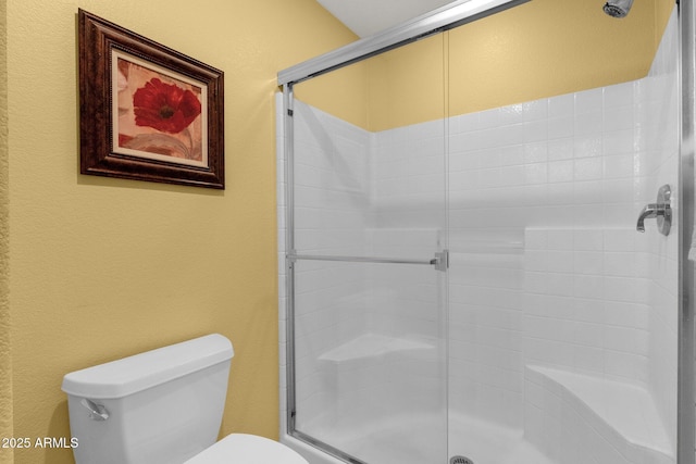 4332 E Cassia Ln, Gilbert, AZ 85298 - bathroom featuring toilet, a shower stall, and a textured wall