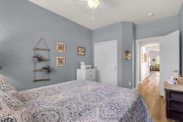 4332 E Cassia Ln, Gilbert, AZ 85298 - bedroom with arched walkways, wood finished floors, ceiling fan, and baseboards