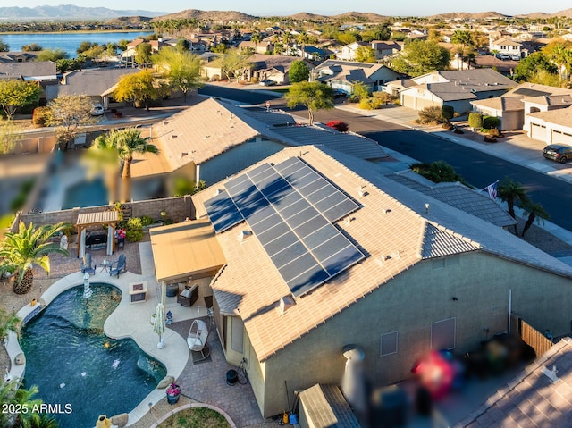 drone / aerial view with a water view and a residential view