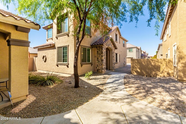 935 E Agua Fria Ln, Avondale, AZ 85323 - mediterranean / spanish home featuring stucco siding, a tiled roof, and a patio