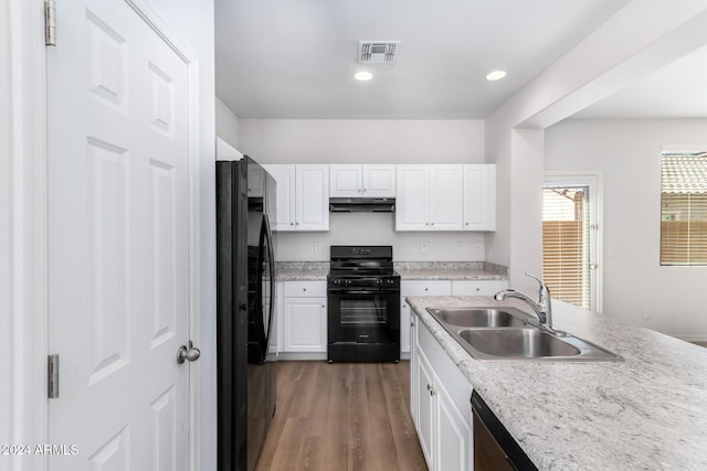 935 E Agua Fria Ln, Avondale, AZ 85323 - kitchen featuring black appliances, under cabinet range hood, a sink, white cabinetry, and recessed lighting
