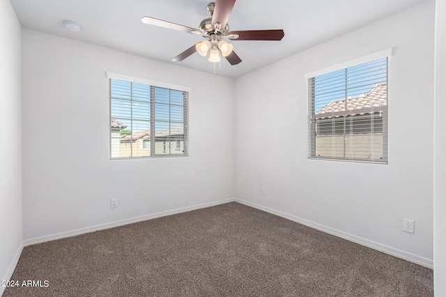 935 E Agua Fria Ln, Avondale, AZ 85323 - carpeted empty room with healthy amount of natural light, baseboards, a smoke detector, and a ceiling fan