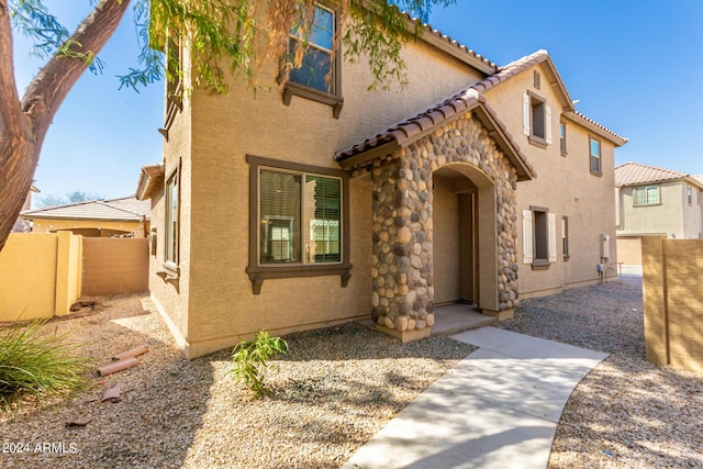 935 E Agua Fria Ln, Avondale, AZ 85323 - mediterranean / spanish home with a tiled roof, stucco siding, and stone siding