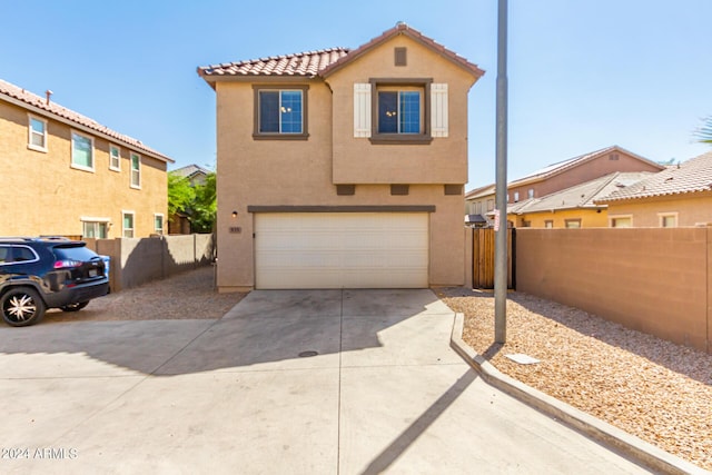 935 E Agua Fria Ln, Avondale, AZ 85323 - view of front facade with stucco siding, a garage, concrete driveway, and a tiled roof