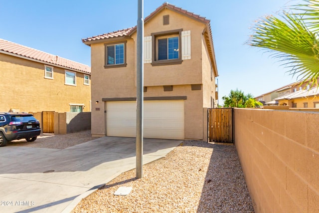 935 E Agua Fria Ln, Avondale, AZ 85323 - view of front of home featuring an attached garage, stucco siding, concrete driveway, and a tile roof