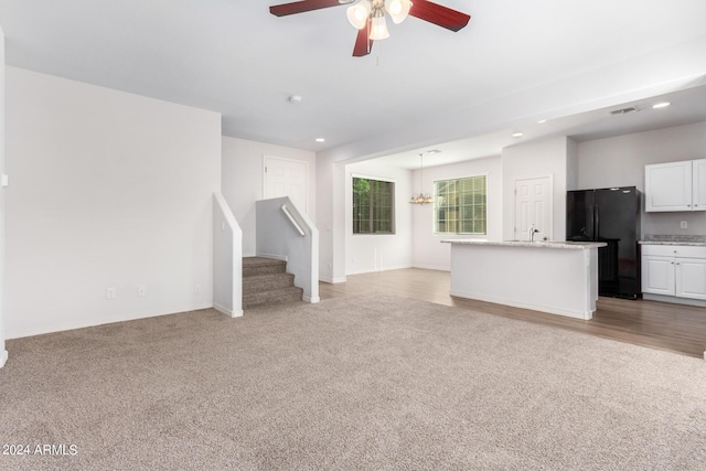 935 E Agua Fria Ln, Avondale, AZ 85323 - unfurnished living room featuring ceiling fan, carpet floors, a chandelier, stairway, and recessed lighting