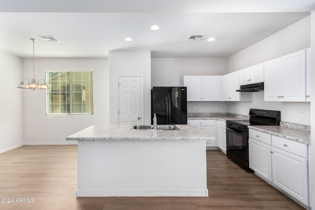 935 E Agua Fria Ln, Avondale, AZ 85323 - kitchen with black appliances, under cabinet range hood, a sink, white cabinetry, and recessed lighting
