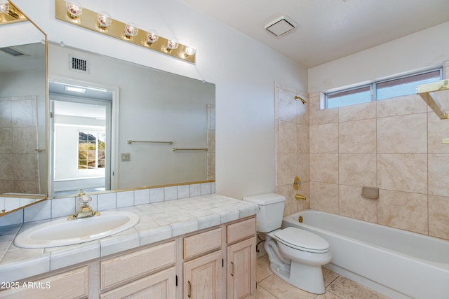 full bathroom with vanity, a wealth of natural light, tile patterned floors, and tiled shower / bath