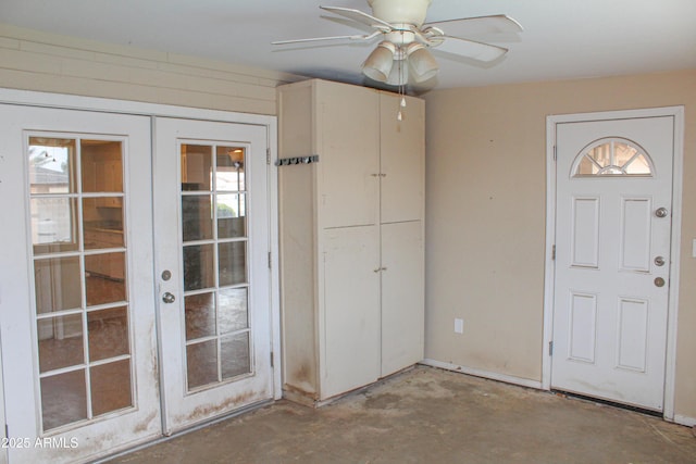 entryway featuring french doors, unfinished concrete flooring, and ceiling fan