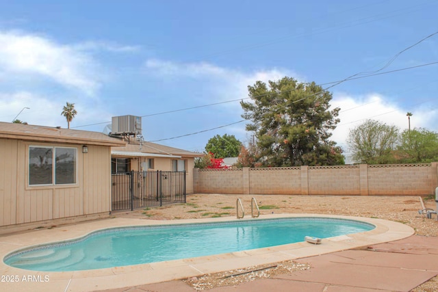 view of pool featuring a fenced in pool, a patio area, central AC unit, and a fenced backyard