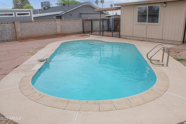 view of swimming pool featuring a patio area, a fenced backyard, a fenced in pool, and cooling unit