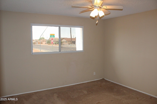 unfurnished room featuring a textured ceiling, a ceiling fan, and carpet floors
