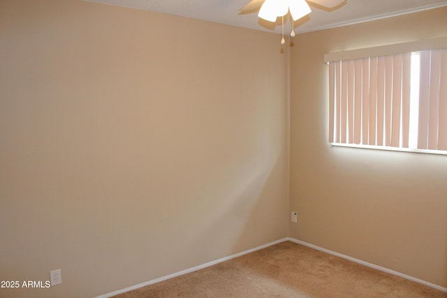spare room with carpet, baseboards, and ceiling fan