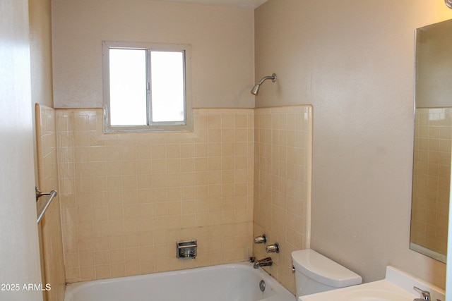 bathroom with toilet and bathtub / shower combination