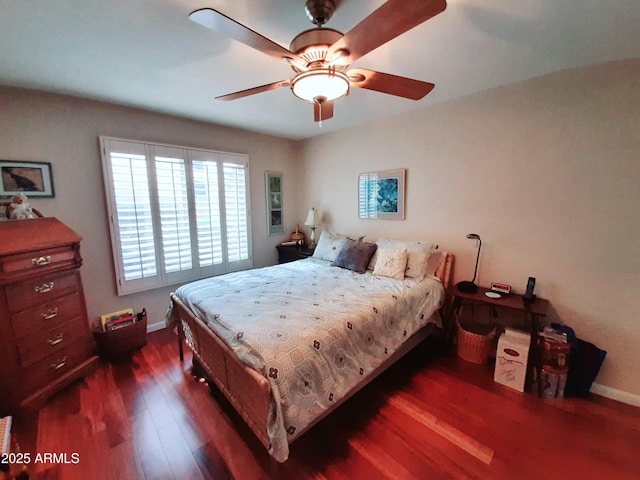 bedroom with ceiling fan, baseboards, and dark wood-style floors
