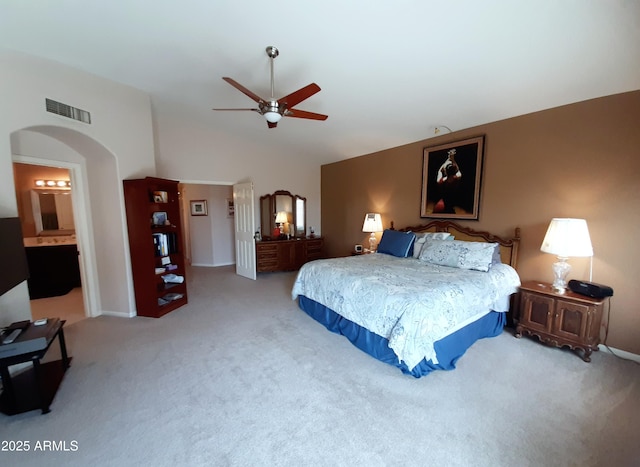 bedroom with arched walkways, vaulted ceiling, visible vents, carpet, and ceiling fan