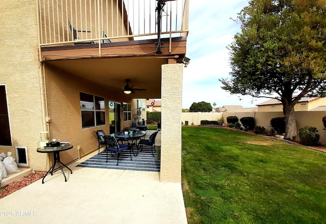 view of patio / terrace featuring a fenced backyard, a ceiling fan, a balcony, and outdoor dining area