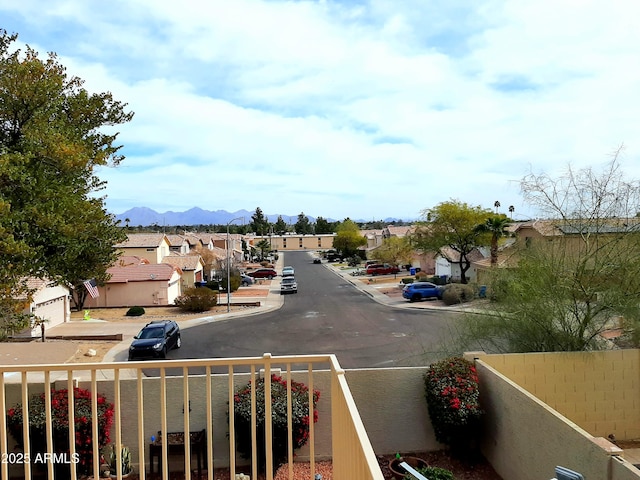 view of street featuring curbs, a mountain view, and a residential view