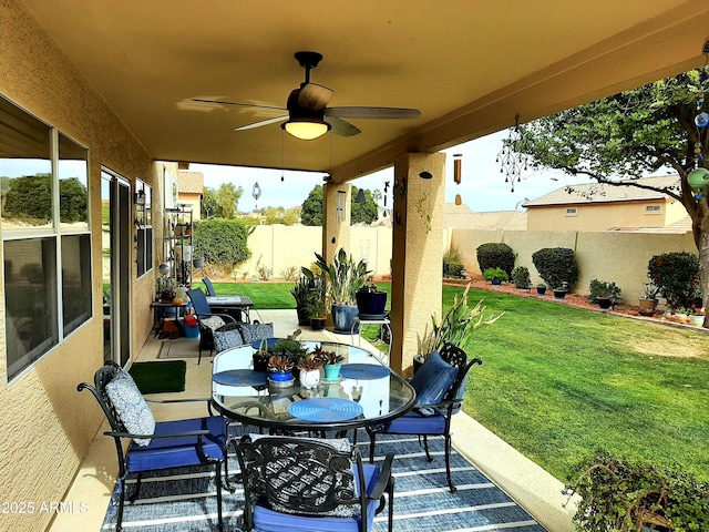 view of patio / terrace with a fenced backyard, a ceiling fan, and outdoor dining area
