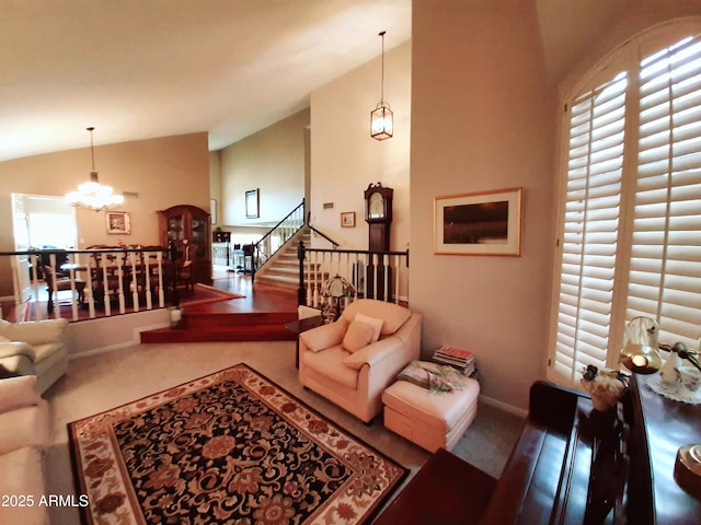 living area featuring lofted ceiling, baseboards, a chandelier, and stairway