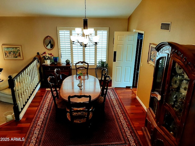 dining room featuring visible vents, baseboards, a chandelier, and dark wood-type flooring