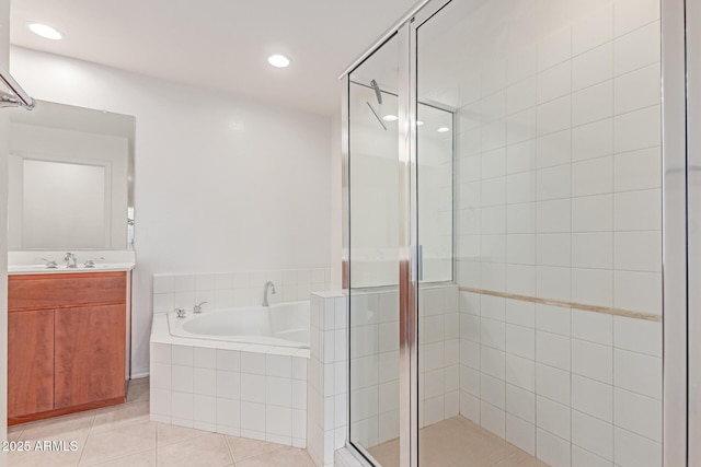 16 W Encanto Blvd Unit 26, Phoenix, AZ 85003 - bathroom featuring a garden tub, a shower stall, tile patterned flooring, vanity, and recessed lighting